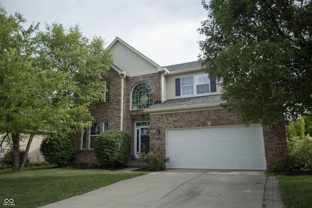 view of front of home featuring a front lawn and a garage