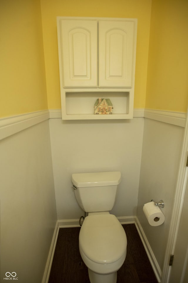 bathroom with toilet and hardwood / wood-style flooring