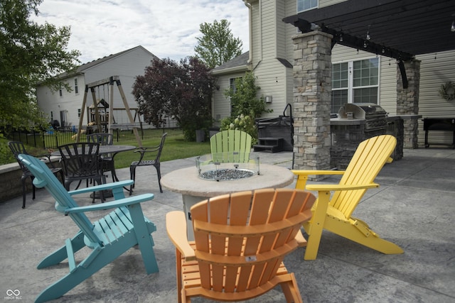 view of patio featuring a grill, an outdoor fire pit, a pergola, and area for grilling