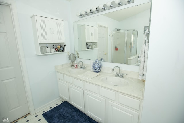 bathroom with vanity and a shower with shower door