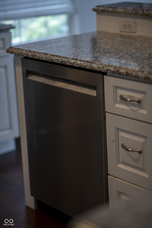 room details with white cabinets and black dishwasher