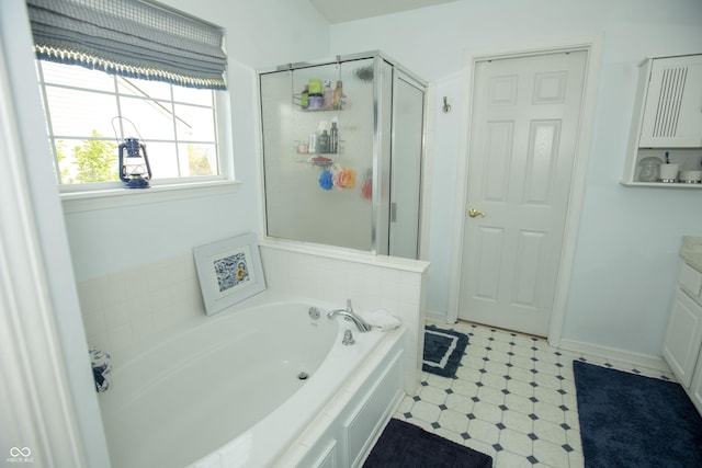 bathroom with independent shower and bath and vanity