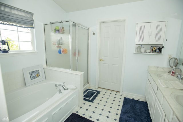 bathroom featuring vanity and independent shower and bath