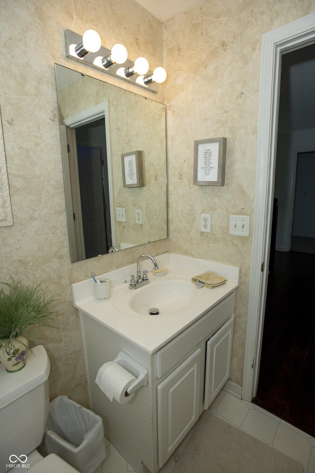 bathroom featuring tile patterned flooring, vanity, and toilet