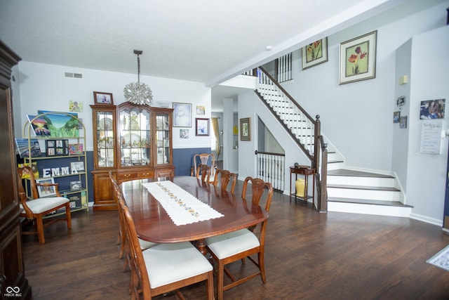 dining room with a notable chandelier and dark hardwood / wood-style flooring