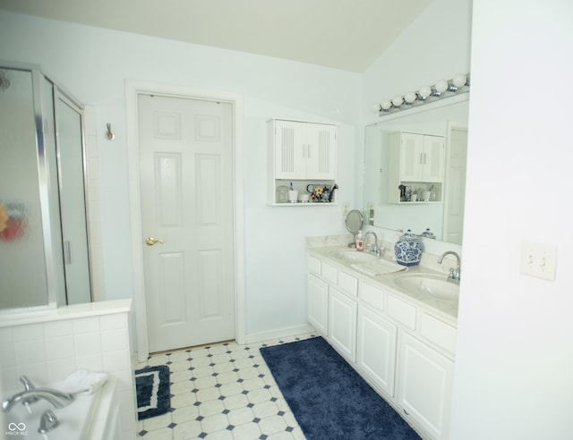 bathroom featuring an enclosed shower, vanity, and vaulted ceiling