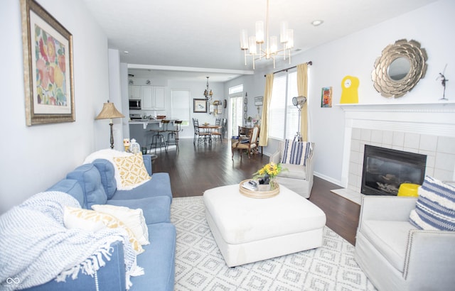 living room featuring a fireplace, light hardwood / wood-style flooring, and a chandelier