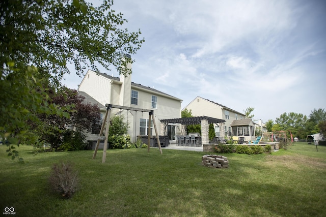 back of property featuring a patio, a yard, a pergola, a playground, and a fire pit