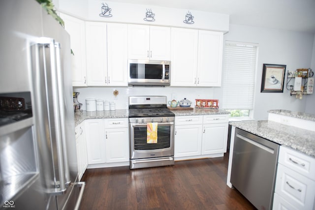 kitchen featuring stainless steel appliances, dark hardwood / wood-style flooring, white cabinetry, and light stone countertops