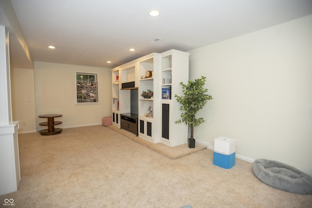 carpeted living room with built in features