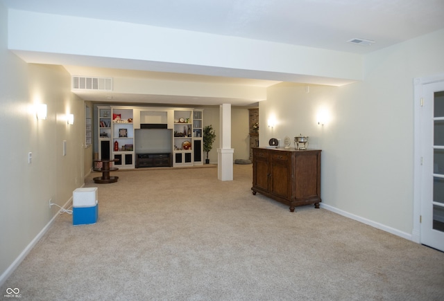 interior space with built in shelves and light carpet