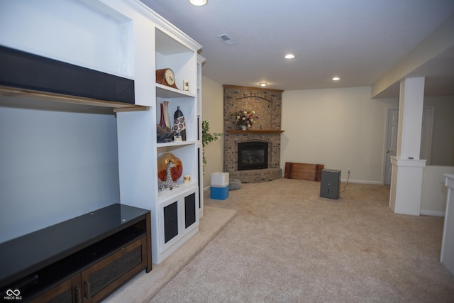 carpeted living room with a brick fireplace and built in features