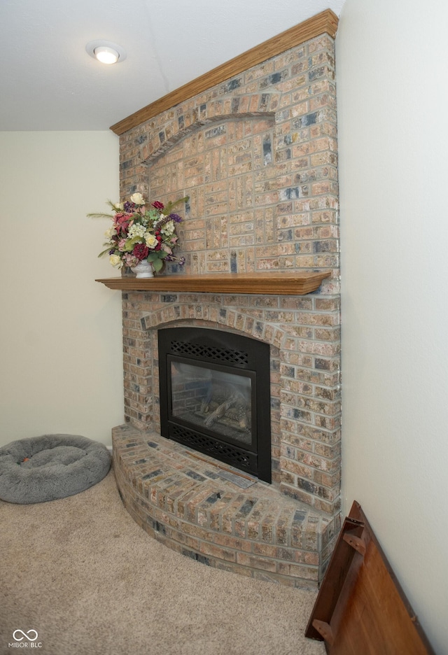 interior details with a brick fireplace and carpet floors