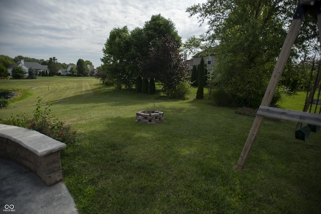 view of yard with an outdoor fire pit