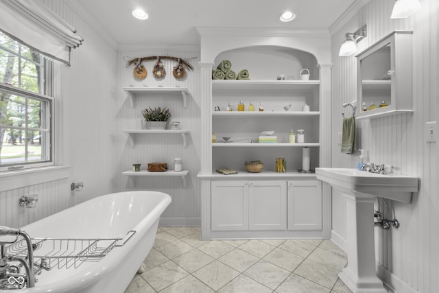 bathroom with ornamental molding, a bath, tile patterned flooring, and built in features