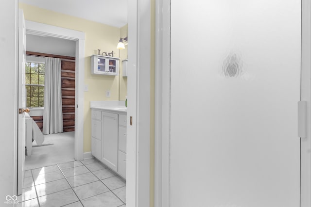 bathroom featuring vanity, tile patterned flooring, and a shower with door