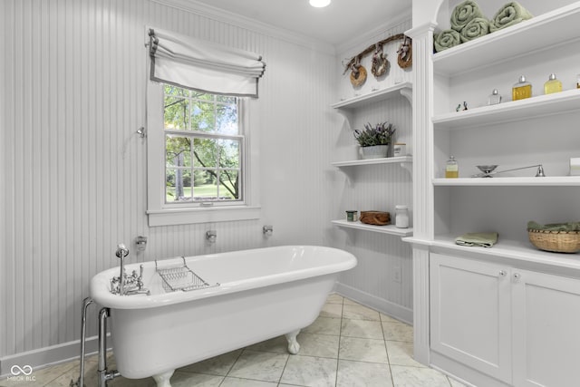 bathroom featuring tile patterned flooring, a bathtub, and ornamental molding