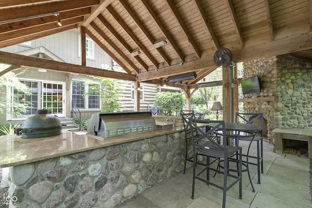 view of patio with a gazebo, area for grilling, exterior kitchen, and a bar