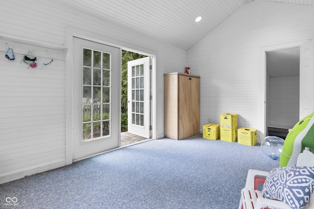 interior space featuring lofted ceiling and carpet flooring