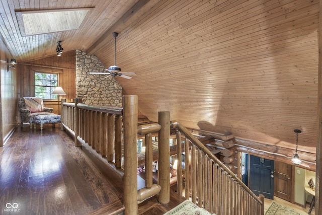 corridor with high vaulted ceiling, wooden walls, hardwood / wood-style floors, and wooden ceiling