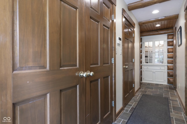 hallway featuring beam ceiling and wooden ceiling