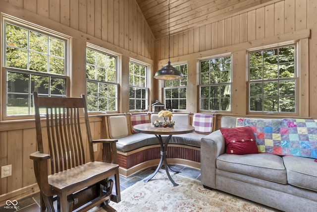 sunroom featuring breakfast area, wood ceiling, and lofted ceiling