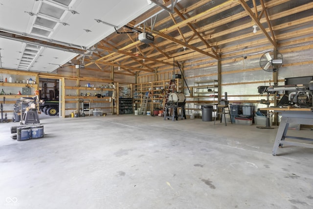 garage featuring a garage door opener and a workshop area