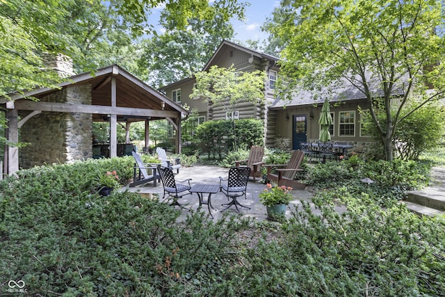 view of patio featuring a fire pit and a gazebo