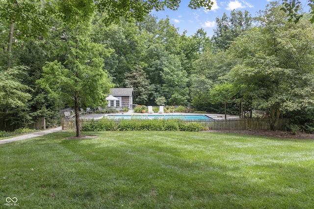 view of yard featuring an outbuilding and a community pool