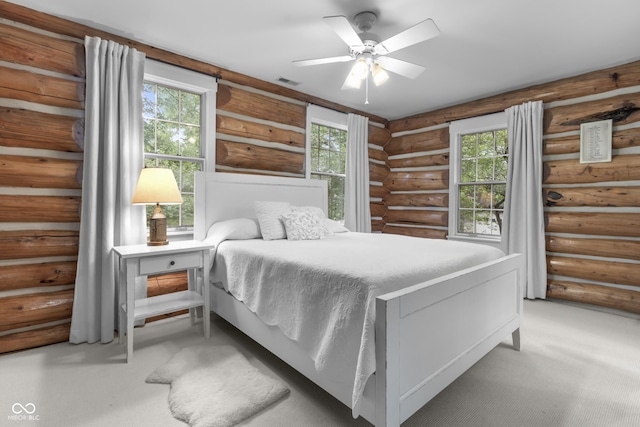 carpeted bedroom featuring ceiling fan and multiple windows