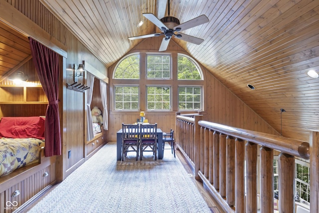 interior space featuring vaulted ceiling, wooden ceiling, and wooden walls