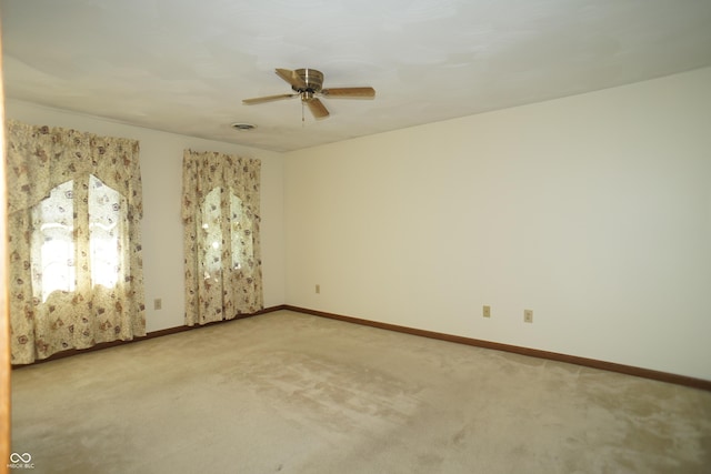 carpeted empty room featuring ceiling fan