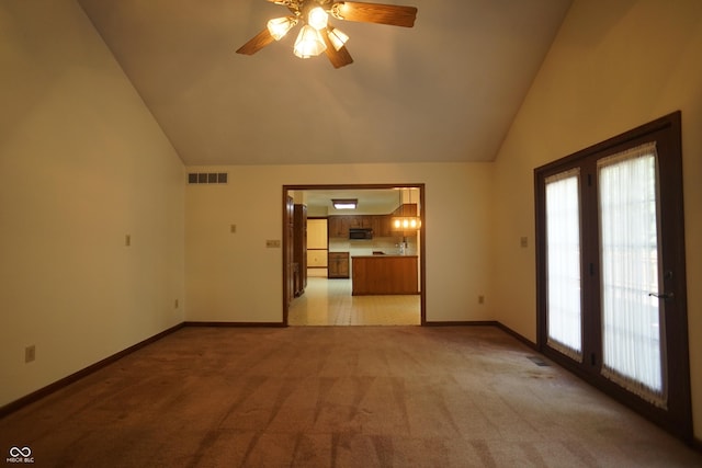 unfurnished living room with lofted ceiling, light carpet, and ceiling fan