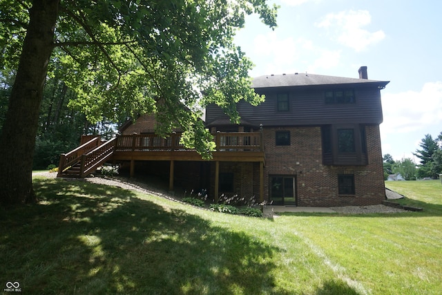 rear view of house with a wooden deck and a yard