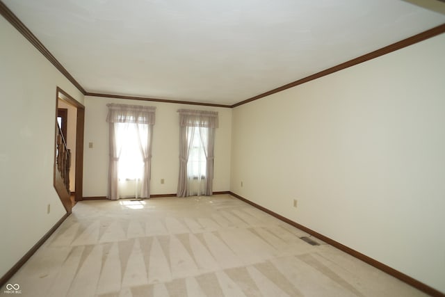 unfurnished room featuring crown molding and light colored carpet