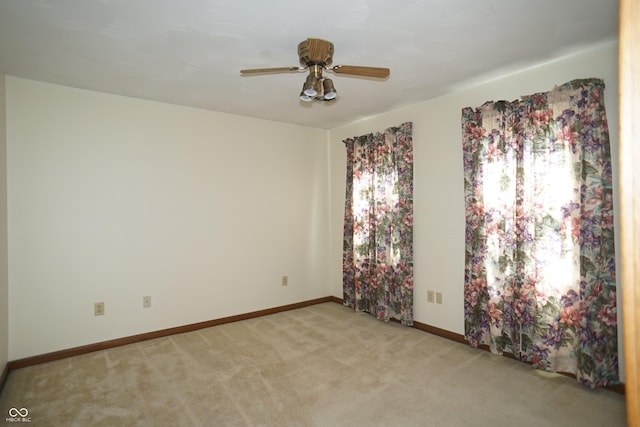 carpeted empty room featuring ceiling fan