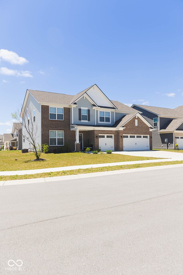 view of front of house featuring a garage and a front lawn