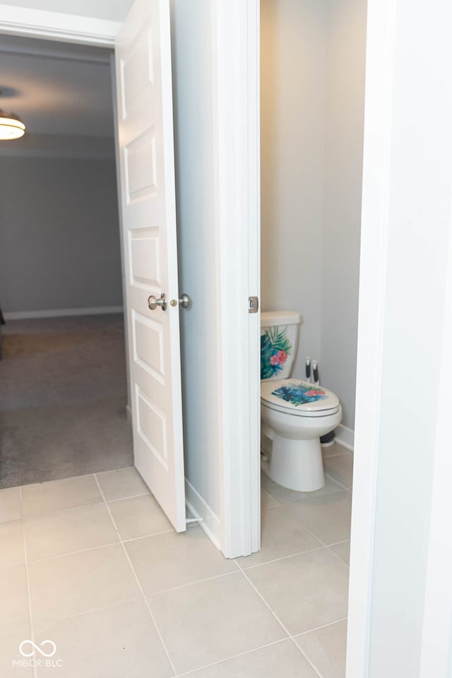 bathroom with toilet and tile patterned floors