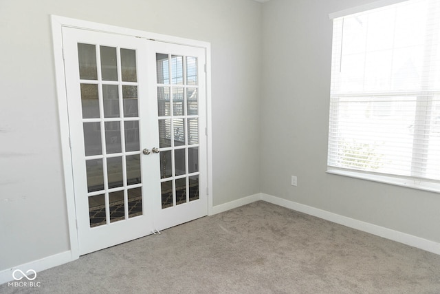 carpeted empty room with french doors and plenty of natural light