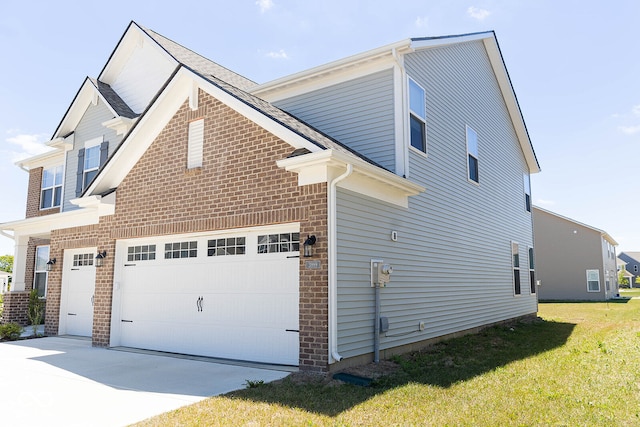 view of home's exterior featuring a lawn and a garage