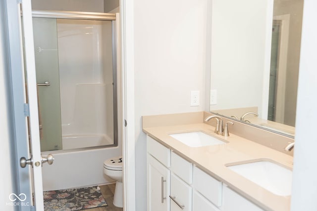 full bathroom with bath / shower combo with glass door, vanity, toilet, and tile patterned floors