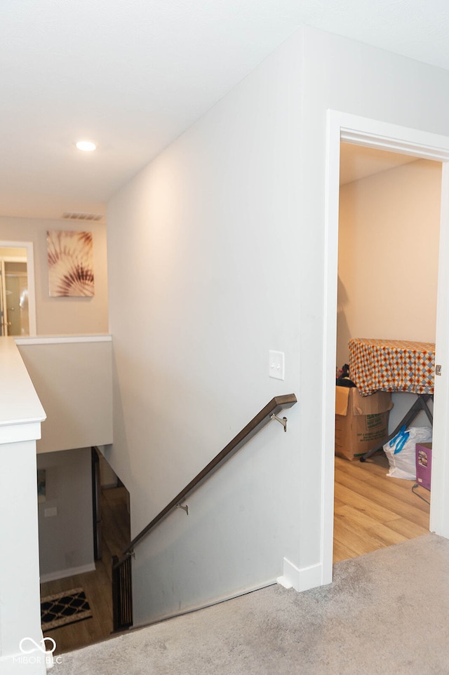 stairway featuring wood-type flooring