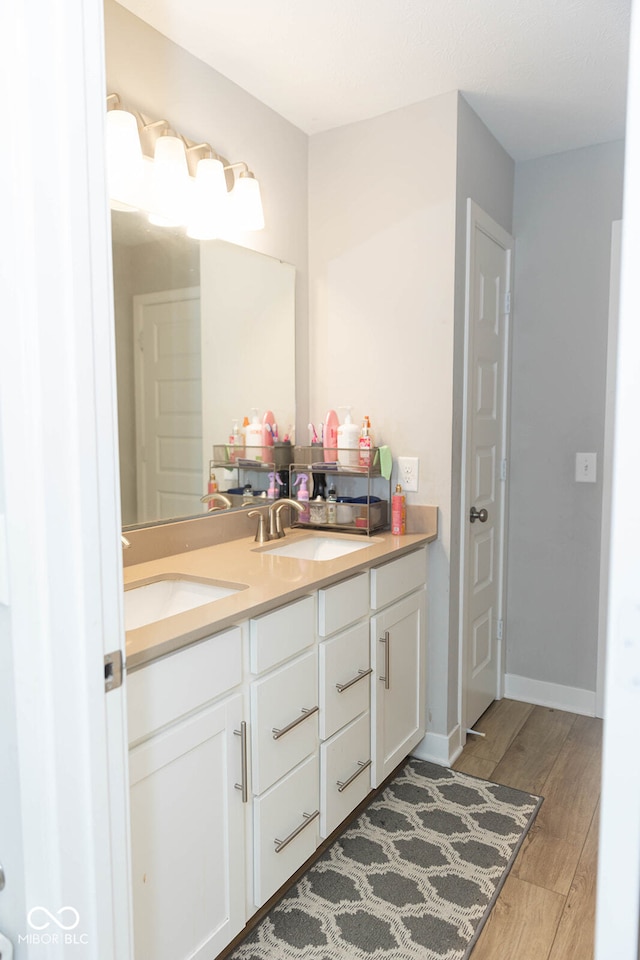 bathroom with vanity and hardwood / wood-style flooring