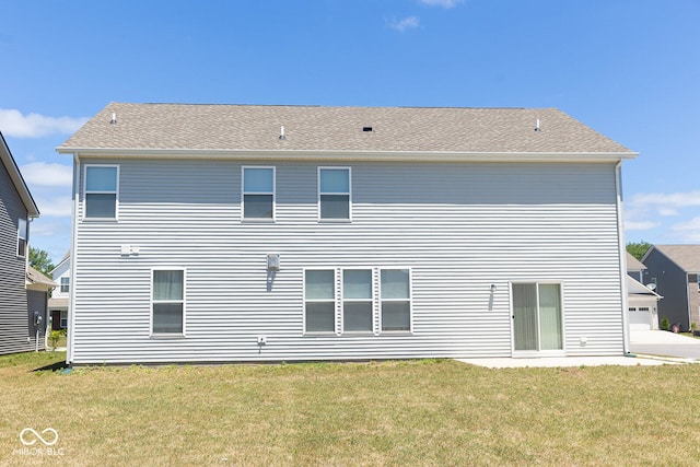 back of property featuring a lawn