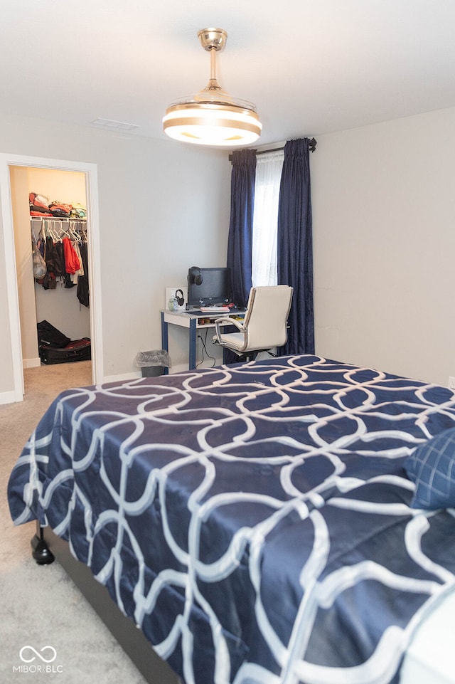 bedroom featuring carpet floors, a closet, and a spacious closet