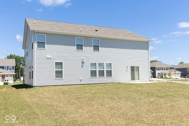 rear view of property with a lawn