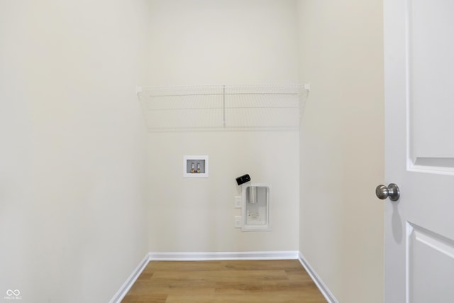 clothes washing area with electric dryer hookup, hardwood / wood-style floors, and hookup for a washing machine