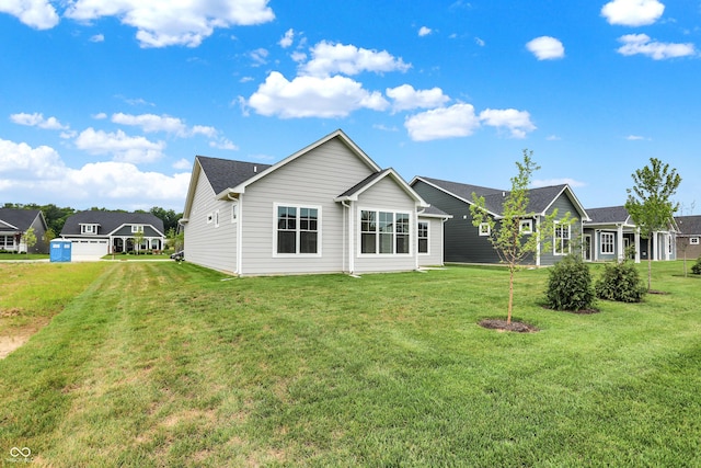 back of house with a lawn