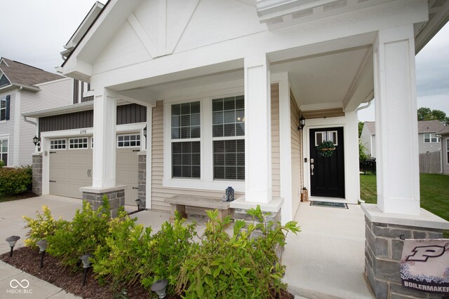 6748 Fallen Leaf Dr, Whitestown, IN 46075 - doorway to property featuring a porch, driveway, and a garage
