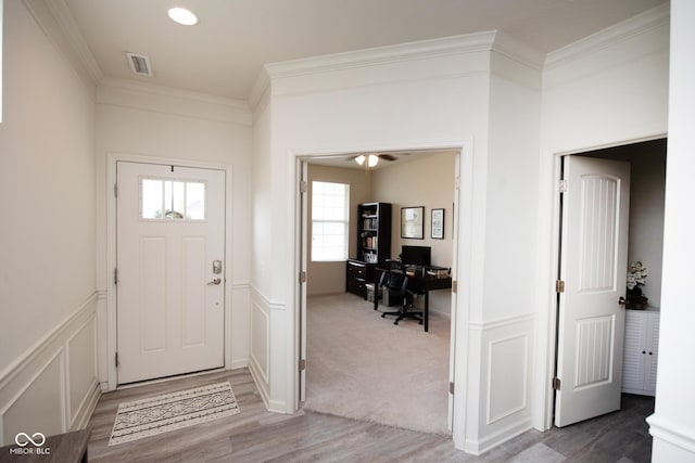 6748 Fallen Leaf Dr, Whitestown, IN 46075 - foyer featuring crown molding, light wood finished floors, and wainscoting